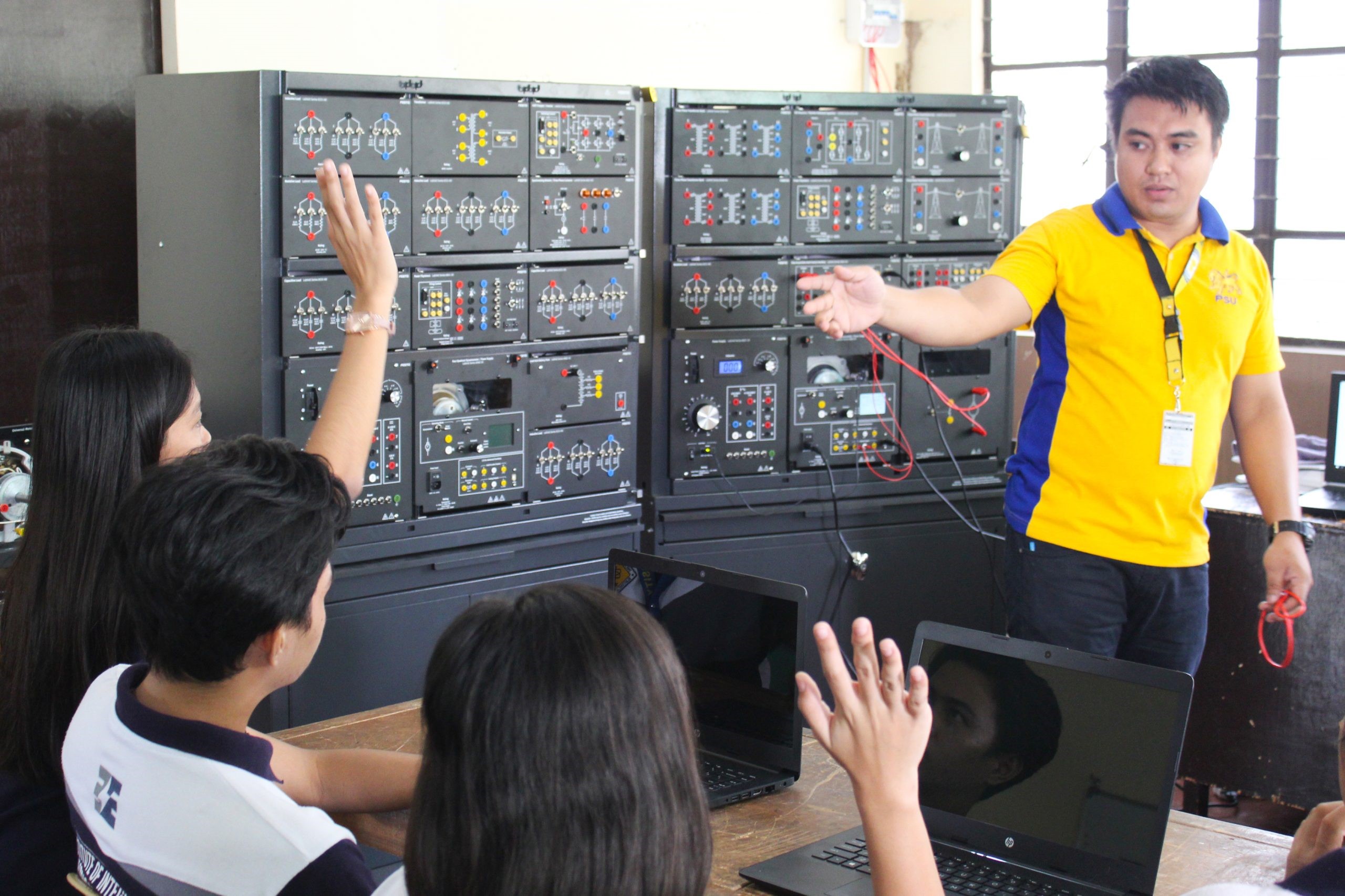 Engr. Harry Errasquin was teaching the subject AC Apparatus using the equipment Electromechanical System to his fourth-year Electrical Engineering class, and asked a volunteer student to perform the activity experiment. Miss Hillary Joy Yambao presented as a volunteer.